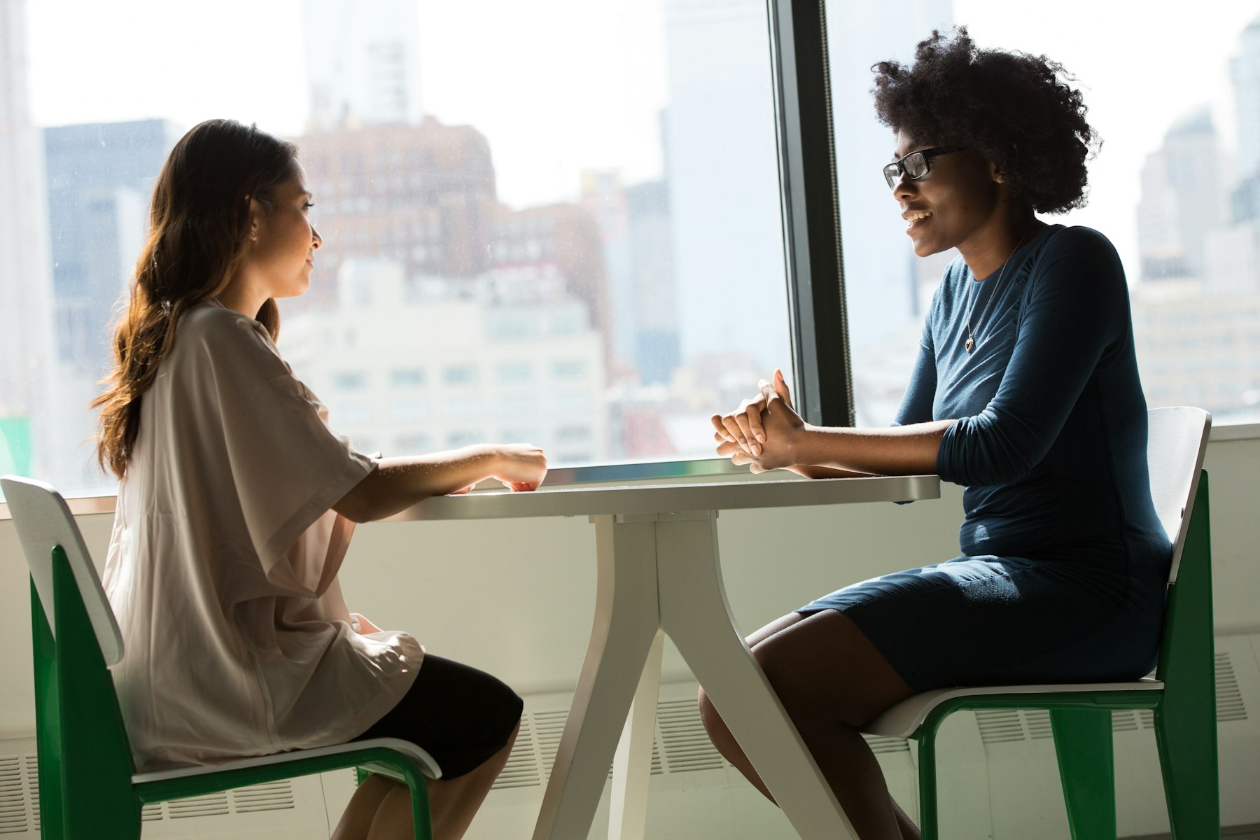 Two business people in conversation across a table